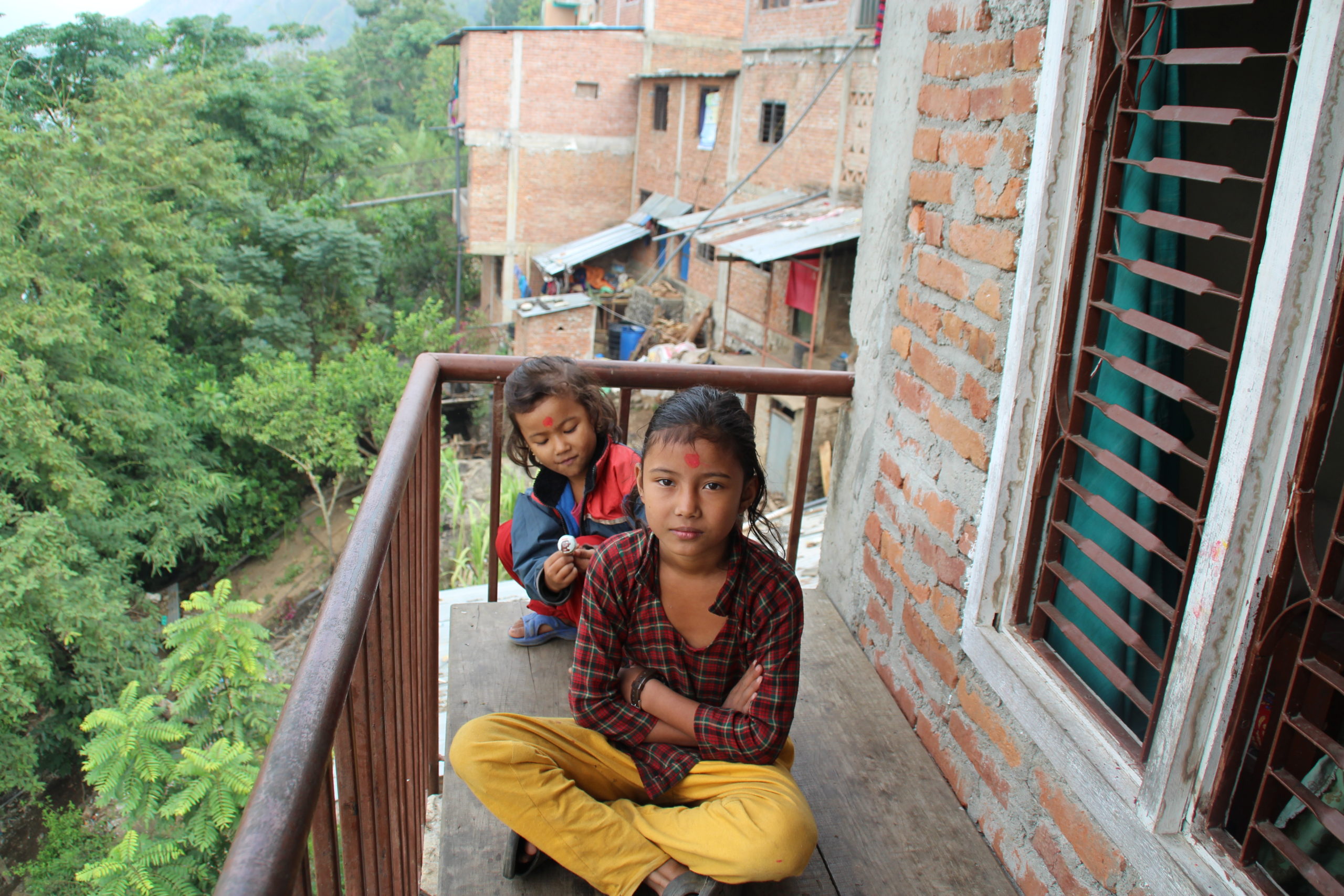 Girls with attitude on their balcony over the valley